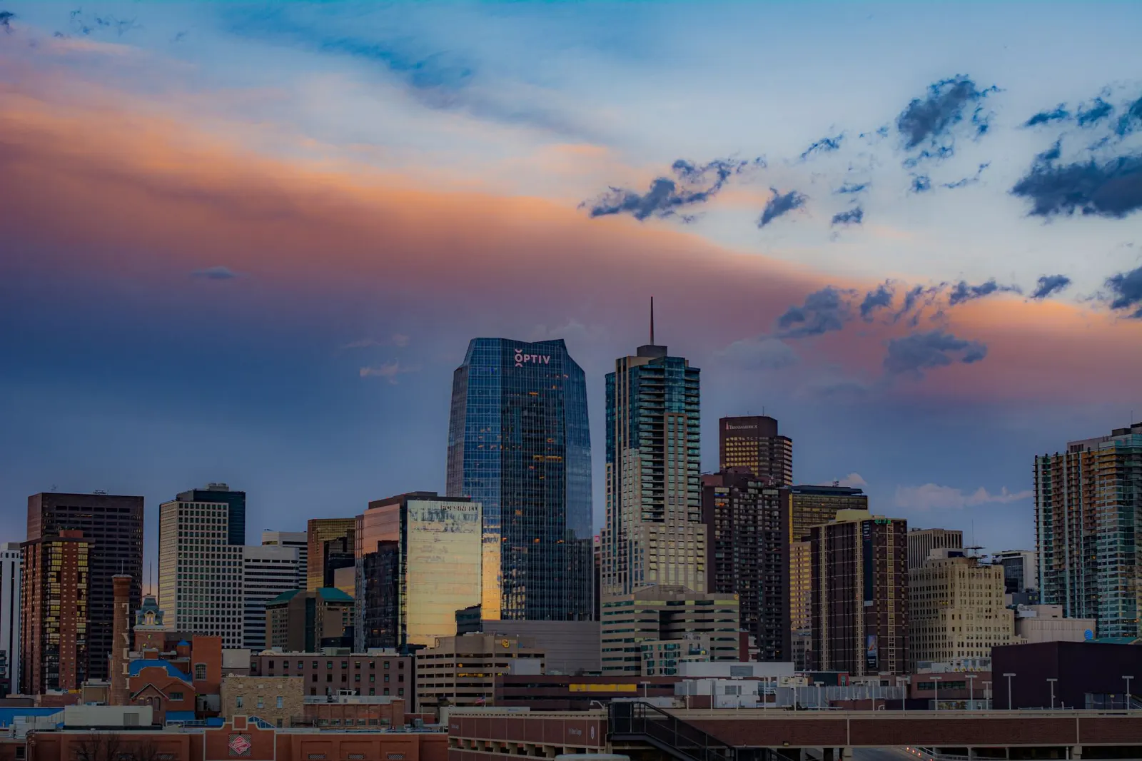 Downtown Denver office towers with the Front Range behind