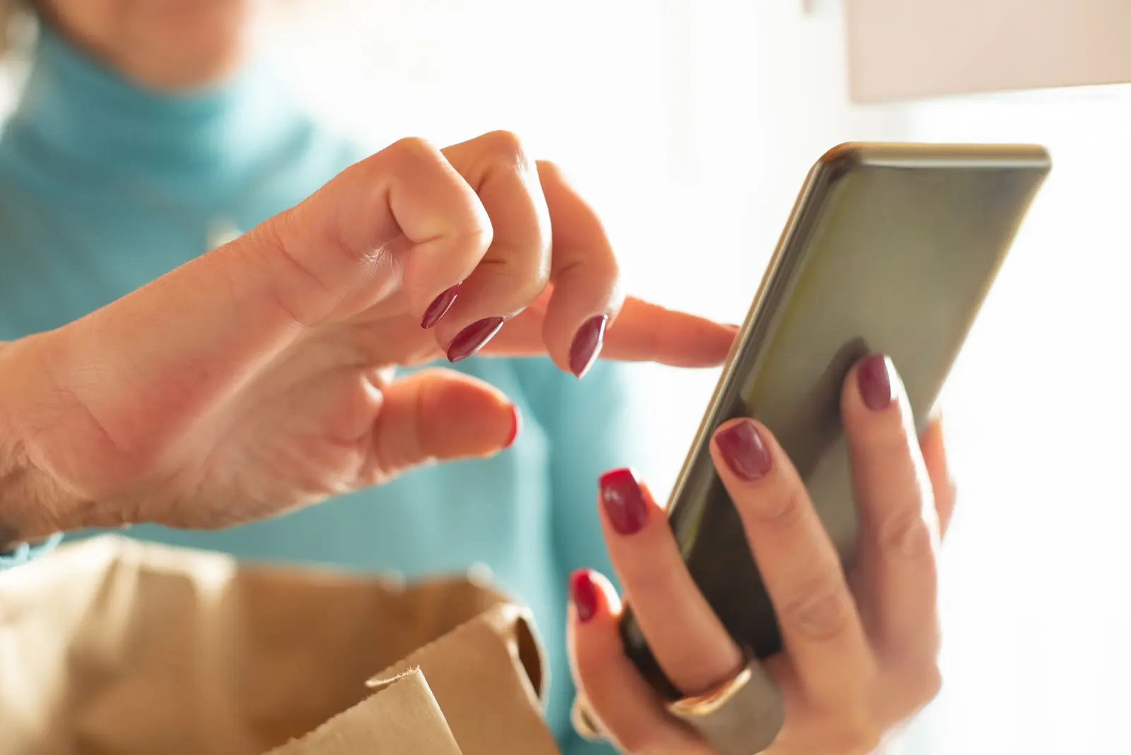 A person holding a smartphone in an office hallway
